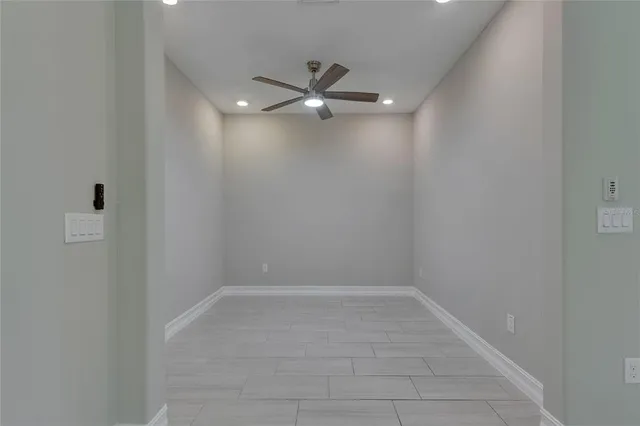 a view of a room with a windows and ceiling fan