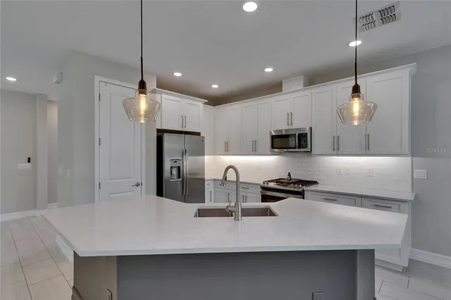 an empty room that has a window and a ceiling fan