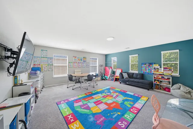 a living room with furniture and a baby crib