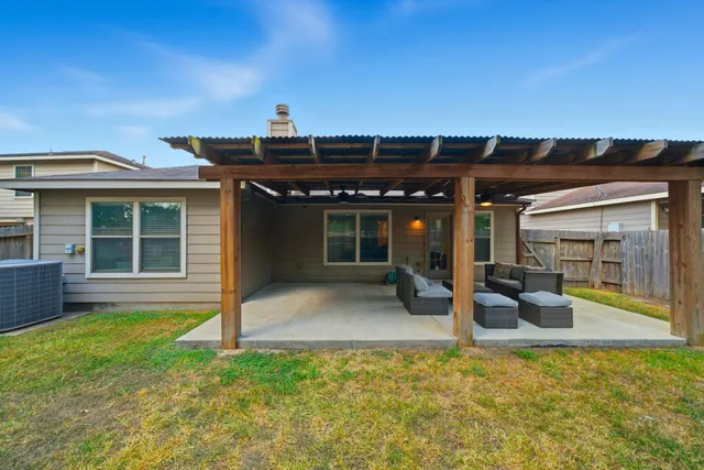 a view of a house with backyard porch and sitting area