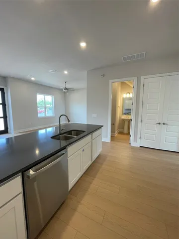 a large kitchen with cabinets and a sink
