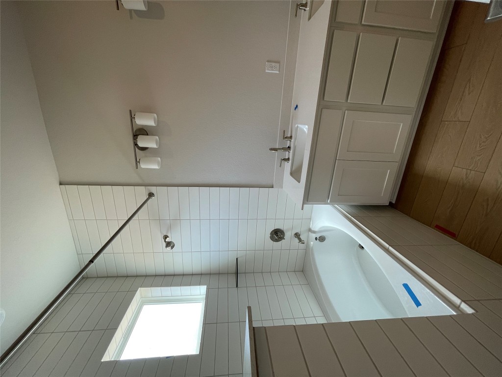 4701 Wally Avenue, Unit A Austin, TX 78721 - Photo 16 of 35 a bathroom with a tub sink and mirror