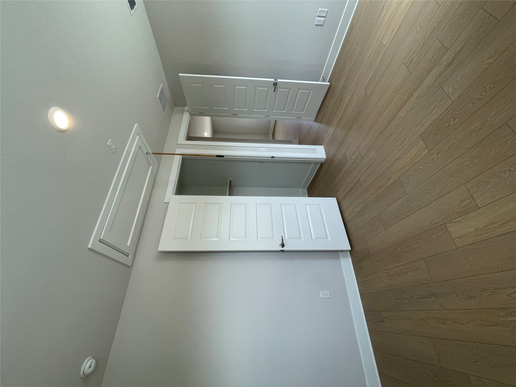 4701 Wally Avenue, Unit A Austin, TX 78721 - Photo 21 of 35 an empty room with wooden floor & closet area
