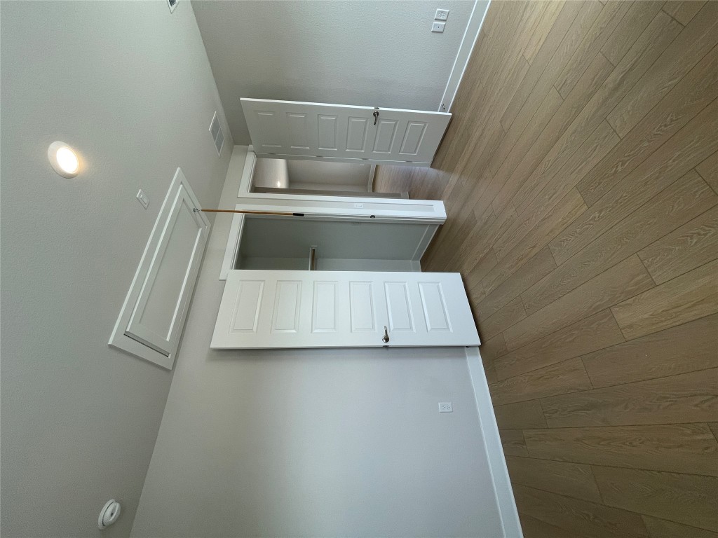 4701 Wally Avenue, Unit A Austin, TX 78721 - Photo 22 of 35 an empty room with wooden floor & closet area