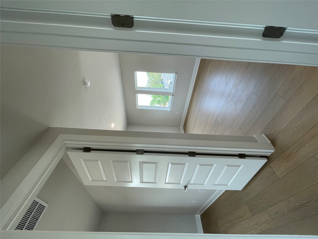 4701 Wally Avenue, Unit A Austin, TX 78721 - Photo 24 of 35 a view of a hallway with closet and wooden floor