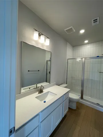 a bathroom with a double vanity sink and mirror with shower