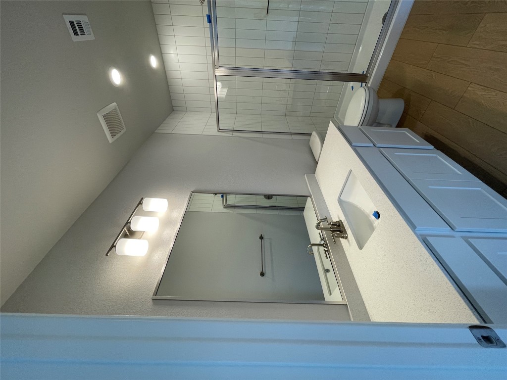 4701 Wally Avenue, Unit A Austin, TX 78721 - Photo 27 of 35 a bathroom with a double vanity sink and mirror with shower