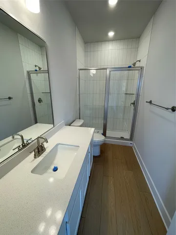 a bathroom with a sink a glass door shower and a sink