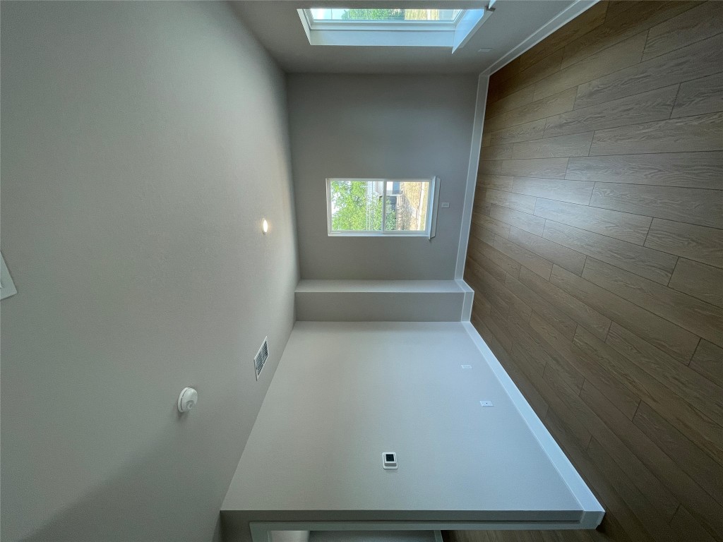4701 Wally Avenue, Unit A Austin, TX 78721 - Photo 32 of 35 an empty room with wooden floor and windows