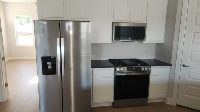 a kitchen with a stove and a refrigerator