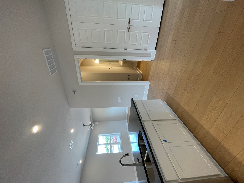 4701 Wally Avenue, Unit A Austin, TX 78721 - Photo 10 of 35 a large kitchen with granite countertop a sink and cabinets