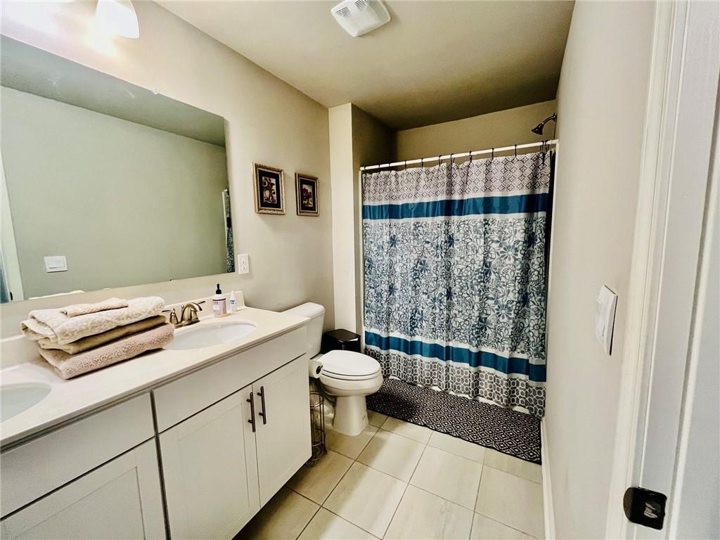 3015 Winding Ridge Waleska, GA 30183 - Photo 35 of 40 a bathroom with a sink a toilet a mirror and shower