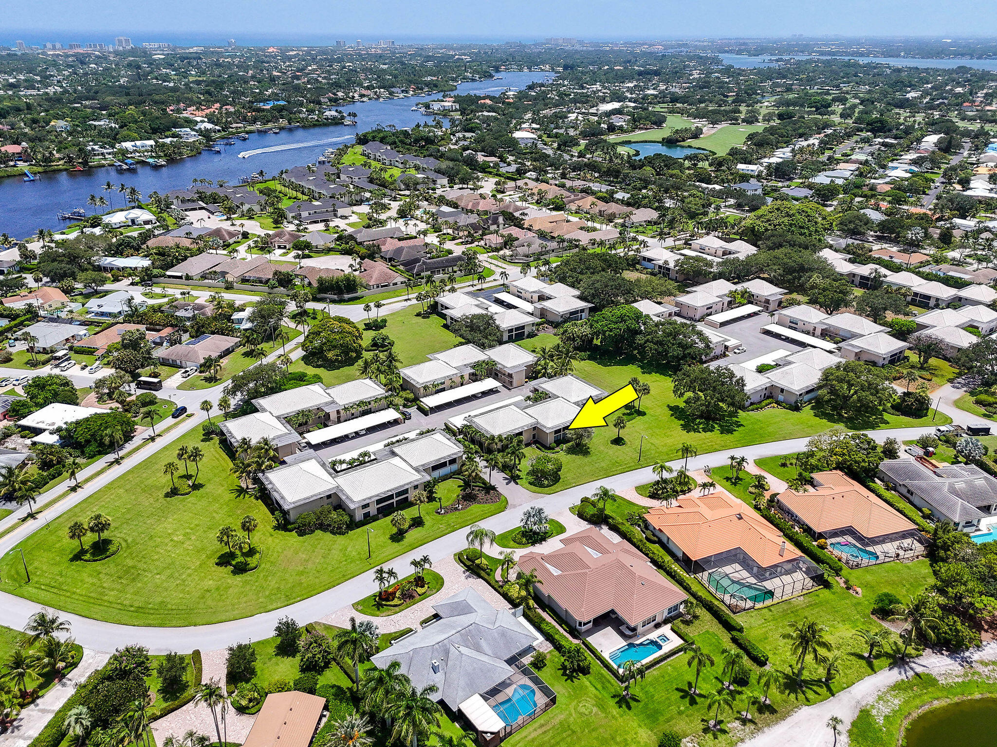 an aerial view of residential houses with outdoor space and trees