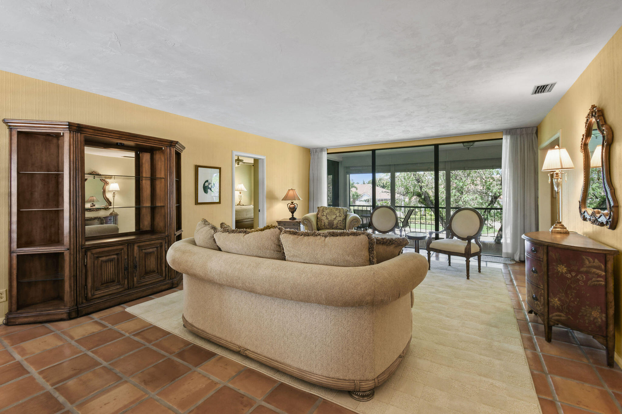 3 Southeast Turtle Creek Drive, Unit E Tequesta, FL 33469 - Photo 11 of 51 a living room with furniture and a floor to ceiling window