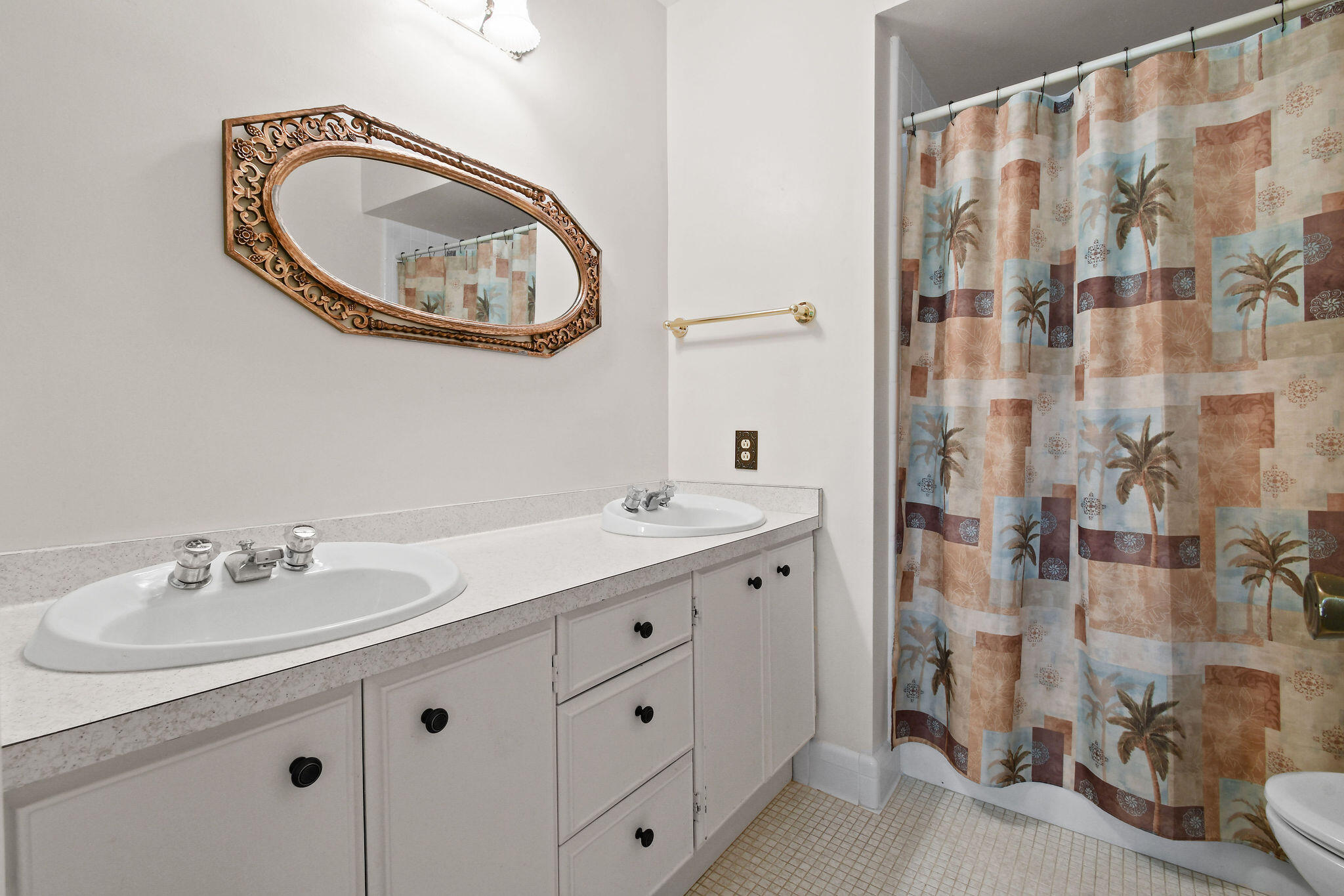 3 Southeast Turtle Creek Drive, Unit E Tequesta, FL 33469 - Photo 19 of 51 a bathroom with a double vanity sink and a mirror