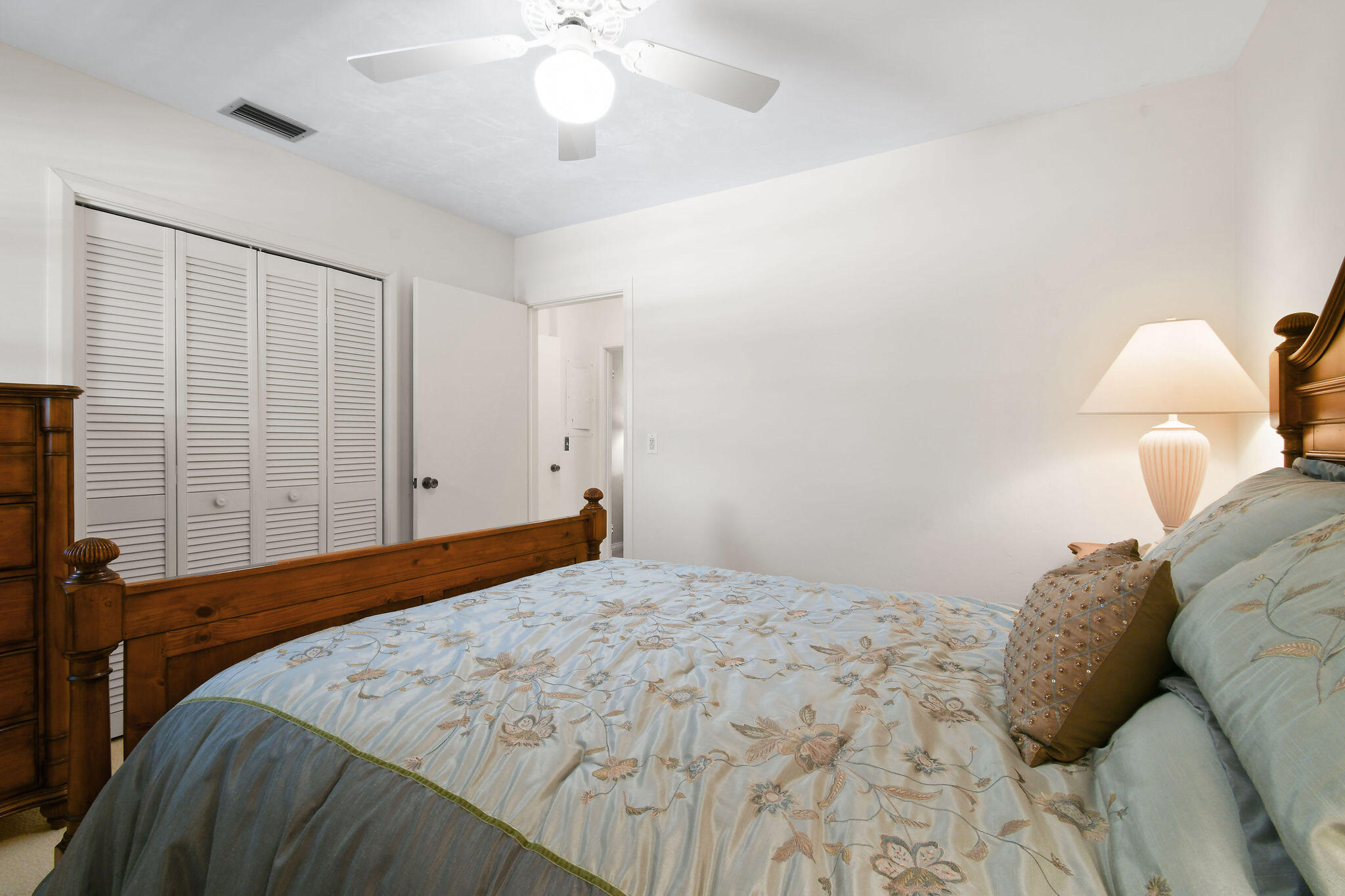 3 Southeast Turtle Creek Drive, Unit E Tequesta, FL 33469 - Photo 21 of 51 a bedroom with a bed and a chandelier