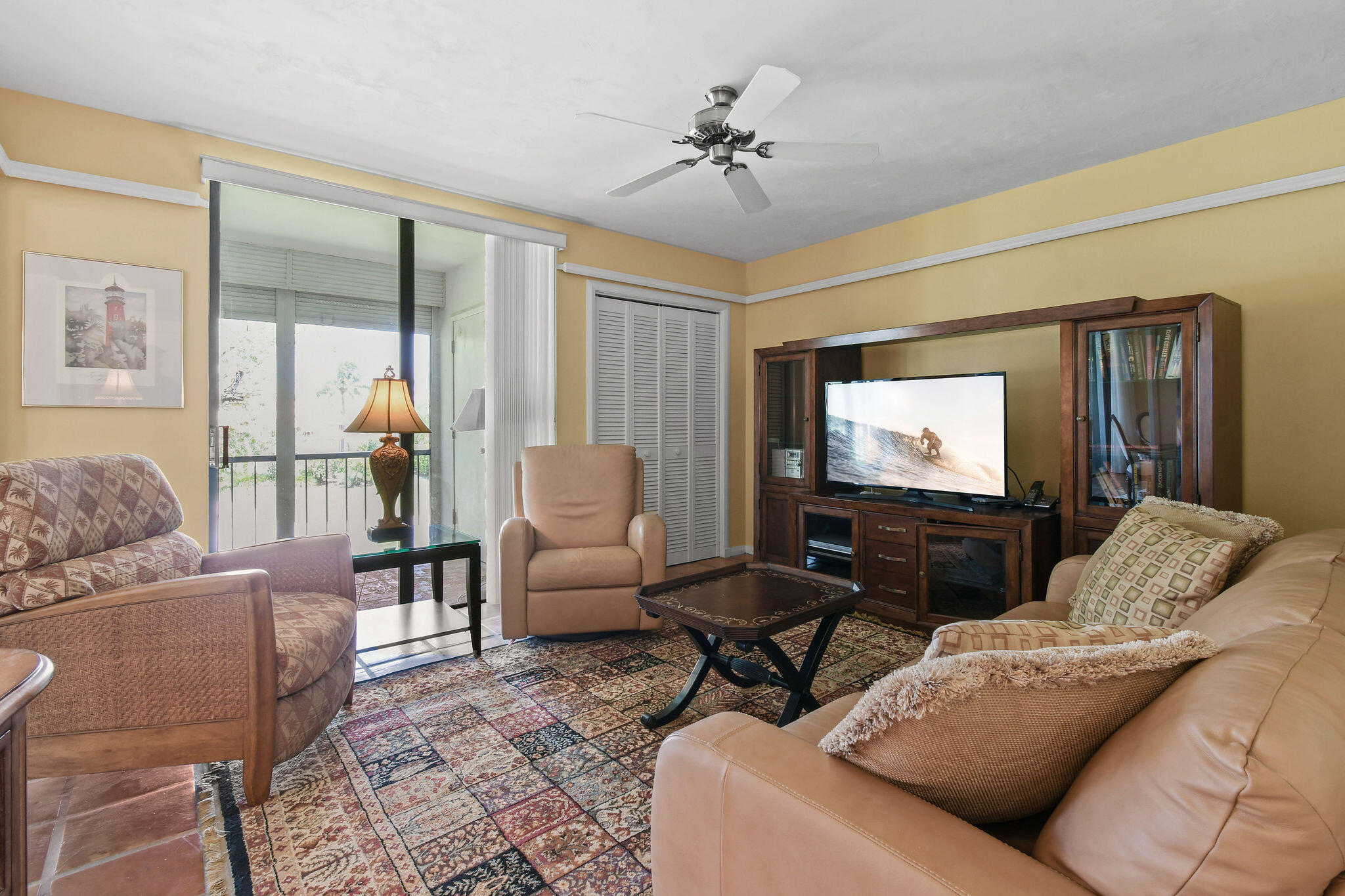 3 Southeast Turtle Creek Drive, Unit E Tequesta, FL 33469 - Photo 27 of 51 a living room with furniture and a flat screen tv