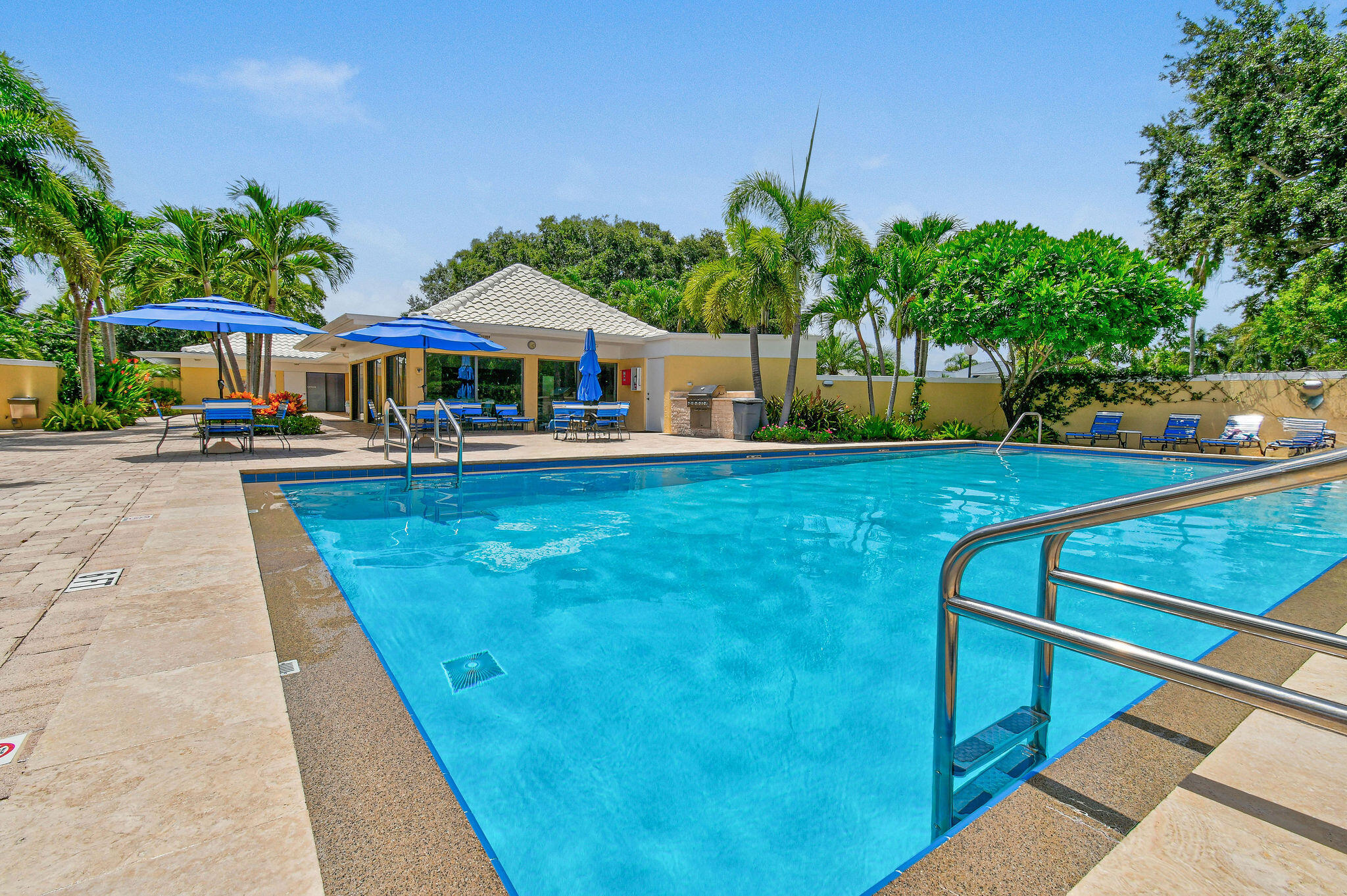 3 Southeast Turtle Creek Drive, Unit E Tequesta, FL 33469 - Photo 33 of 51 a view of a house with pool and chairs