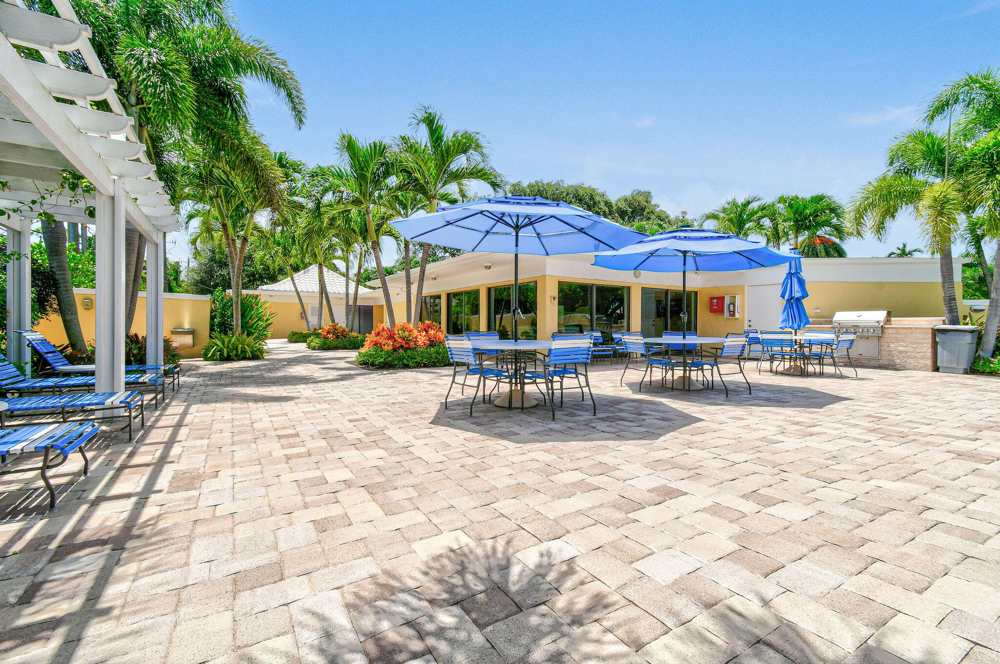 3 Southeast Turtle Creek Drive, Unit E Tequesta, FL 33469 - Photo 34 of 51 a view of patio with swimming pool table and chairs