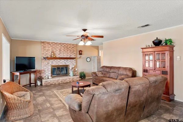 a living room with furniture a fireplace and a flat screen tv