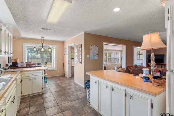 a large white kitchen with a large window