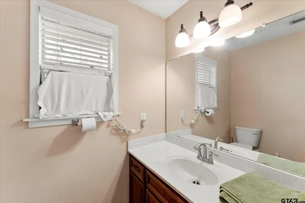 a bathroom with a sink vanity and a mirror