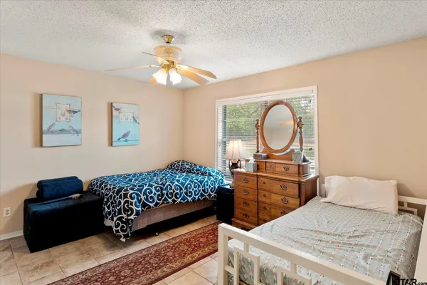 a bedroom with a bed dresser and a window