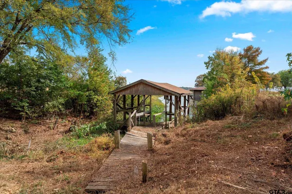 a pathway of a house with a yard