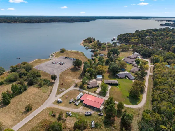 an aerial view of residential house with outdoor space and lake view