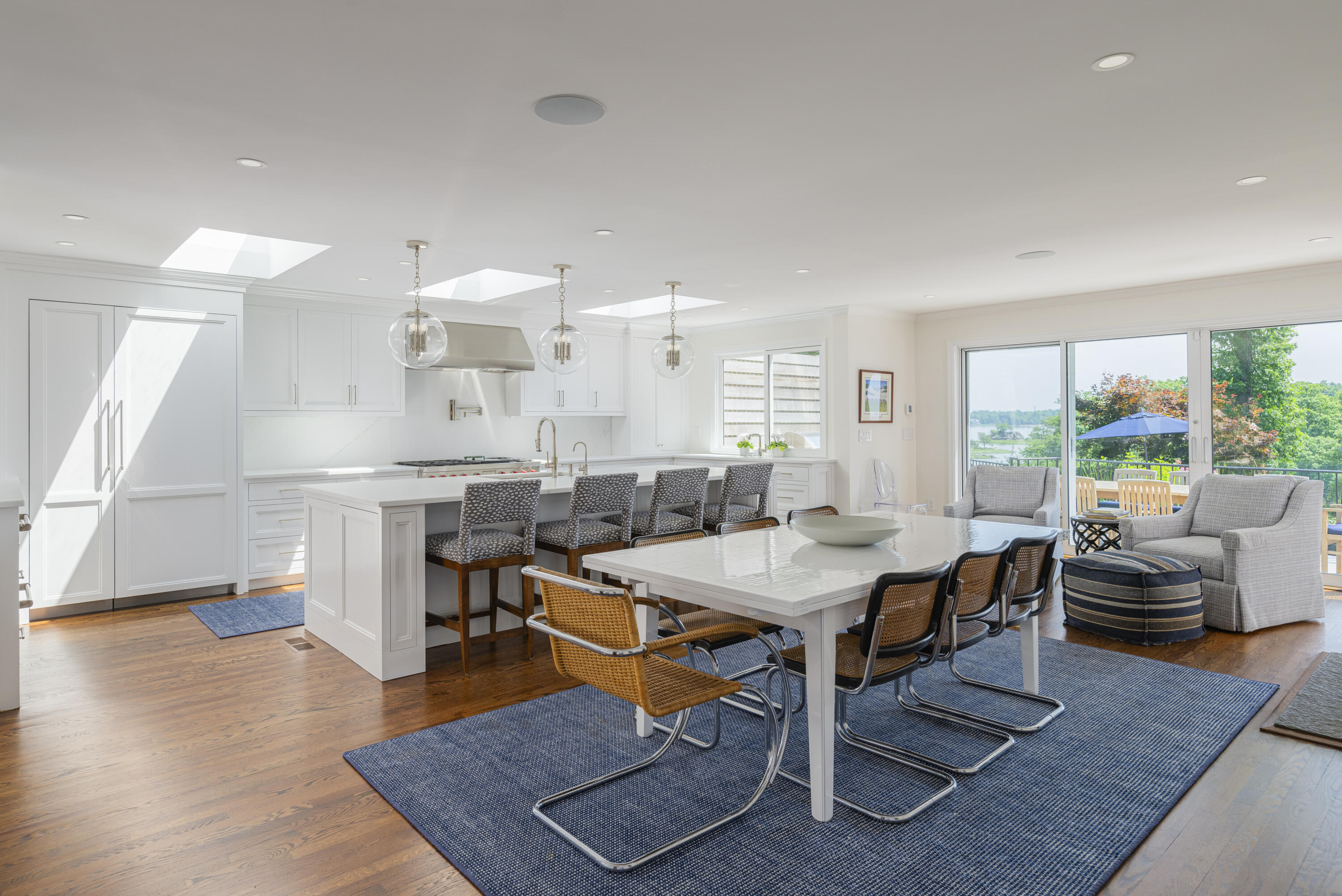 123 Long Neck Point Road Darien, CT 06820 - Photo 12 of 40 a view of a dining room with furniture and wooden floor
