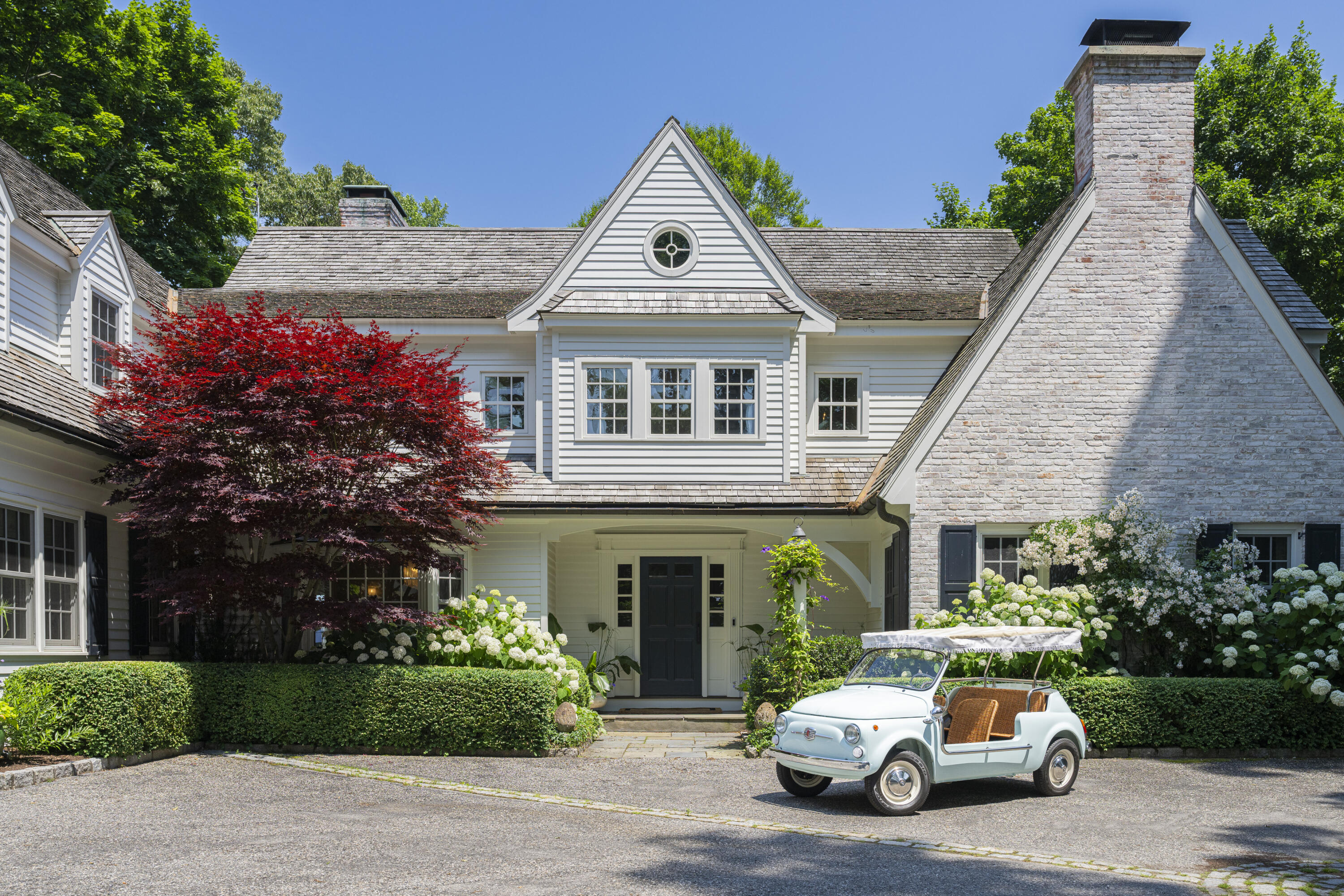 123 Long Neck Point Road Darien, CT 06820 - Photo 2 of 40 a car parked in front of white house