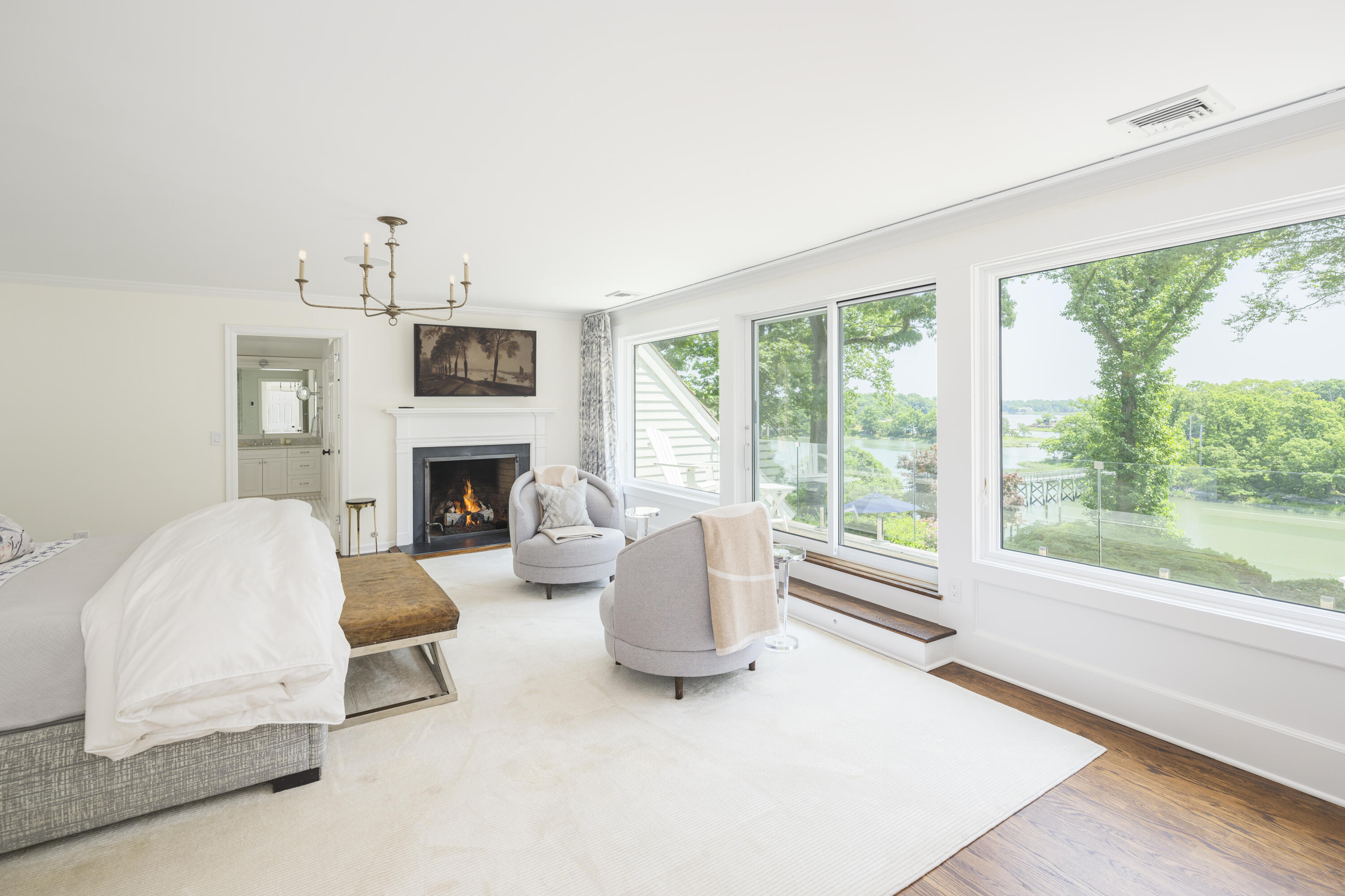 123 Long Neck Point Road Darien, CT 06820 - Photo 22 of 40 a living room with furniture a large window and a fireplace