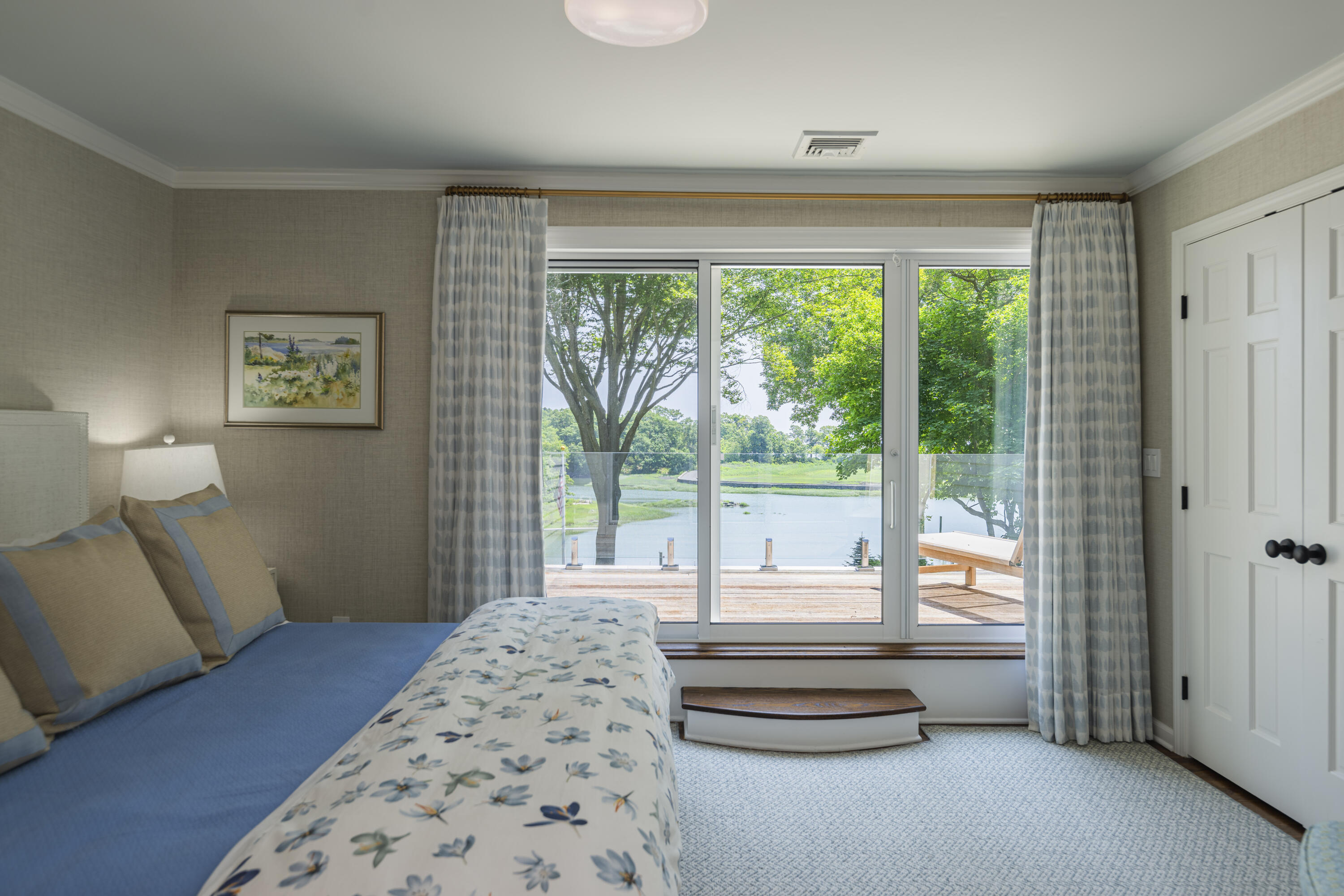 123 Long Neck Point Road Darien, CT 06820 - Photo 26 of 40 a bedroom with a bed and a large window