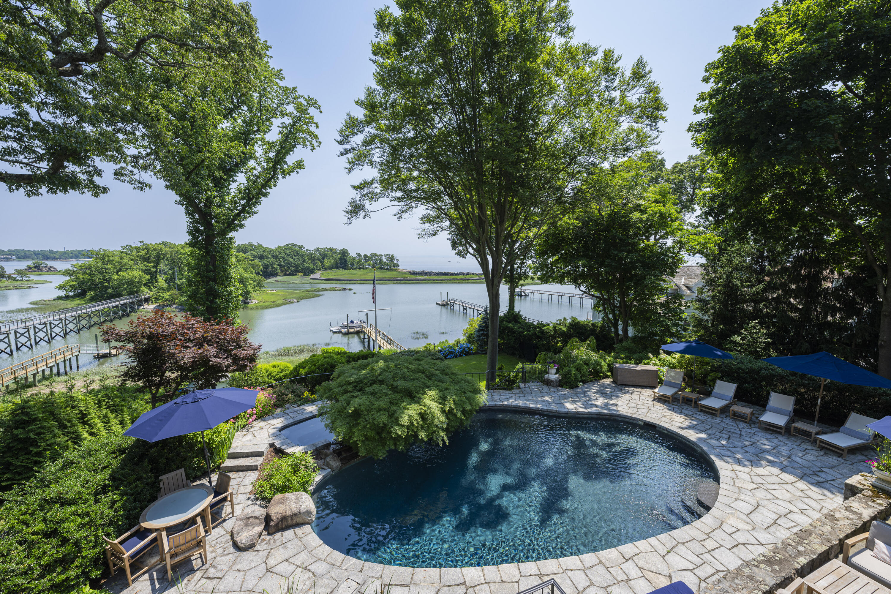 123 Long Neck Point Road Darien, CT 06820 - Photo 36 of 40 a view of a garden with a fountain