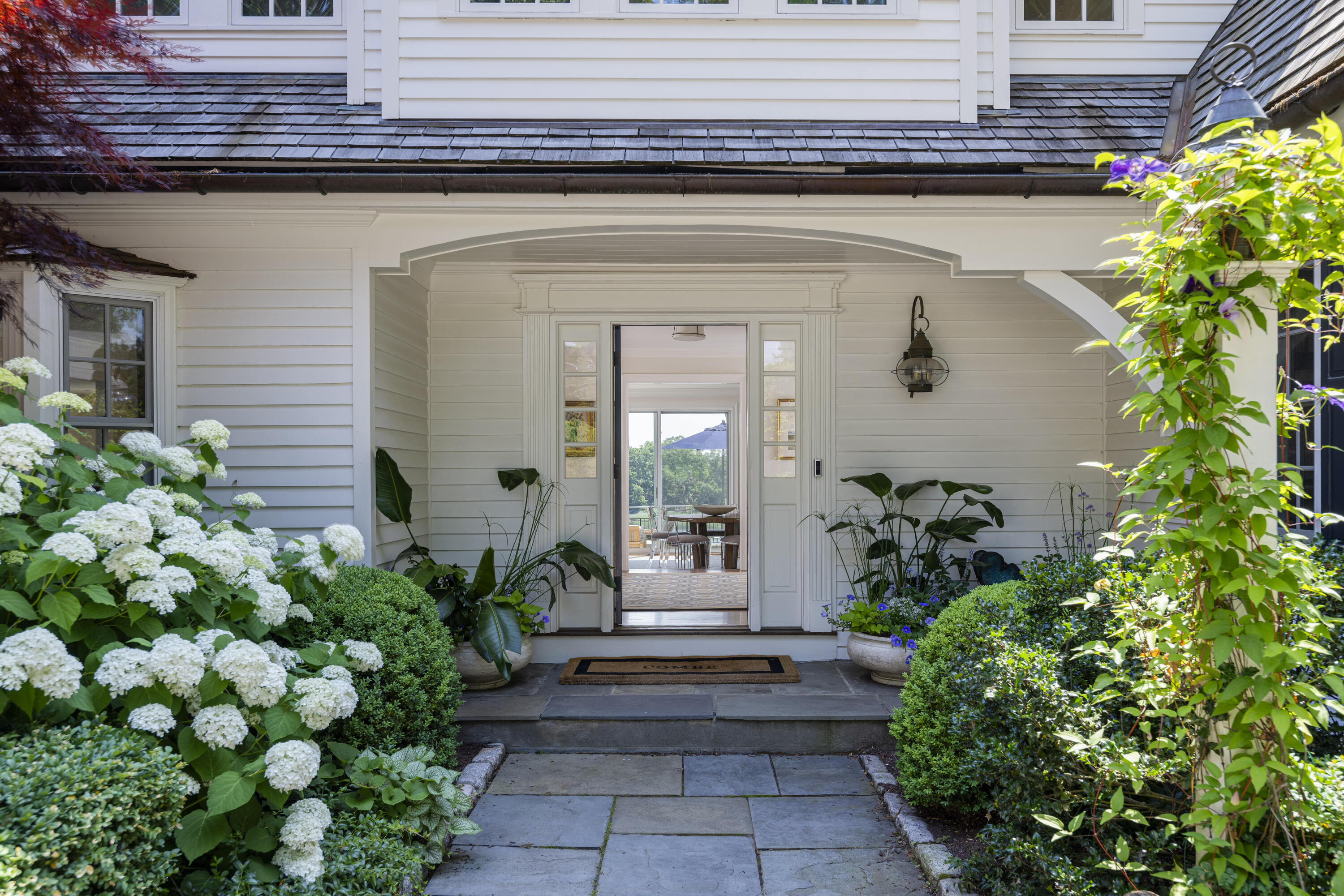 123 Long Neck Point Road Darien, CT 06820 - Photo 8 of 40 a front view of a house with plants