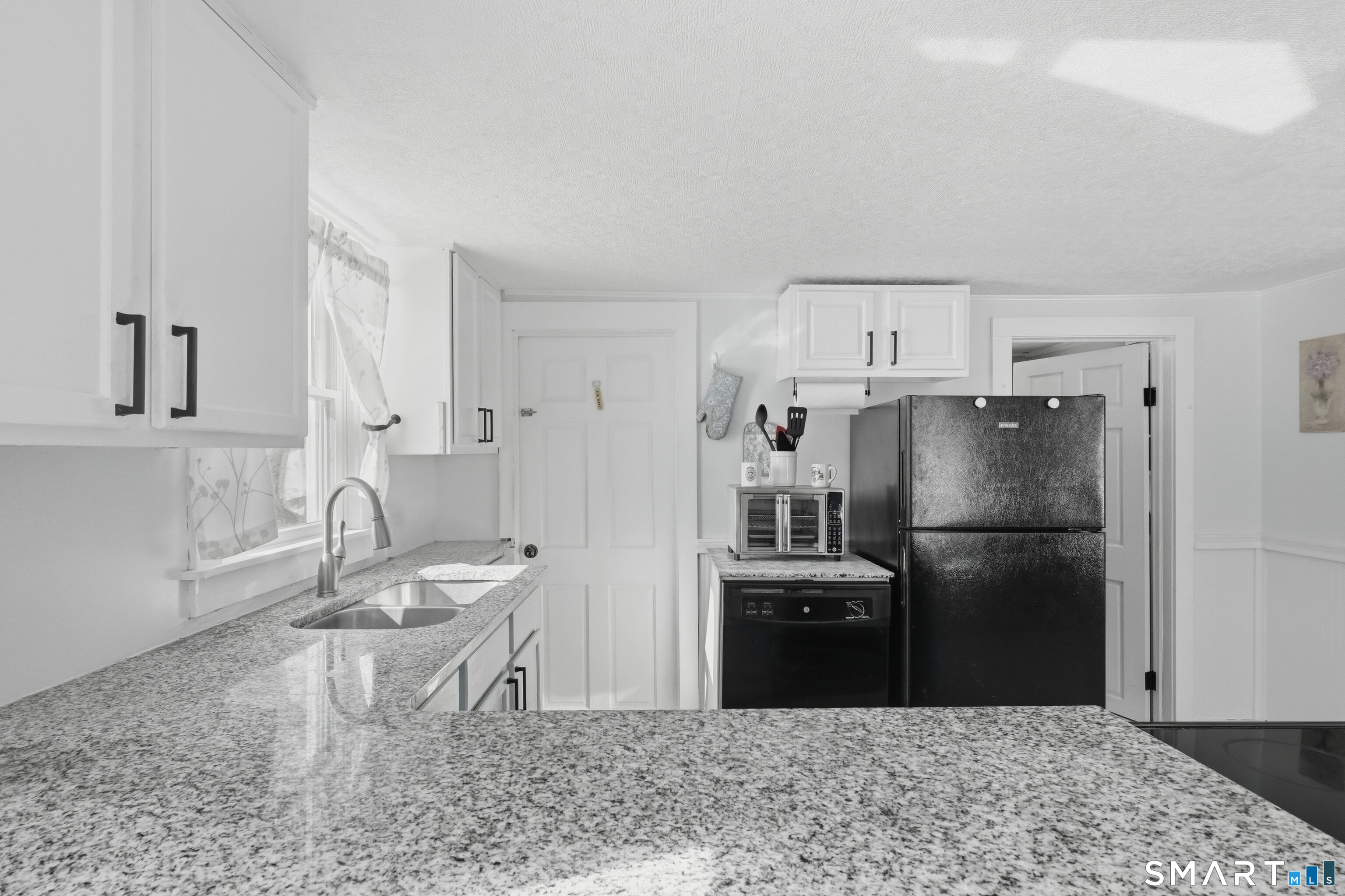 74 Riverside Drive Thompson, CT 06277 - Photo 22 of 25 a kitchen with stainless steel appliances granite countertop a refrigerator a sink a stove and island