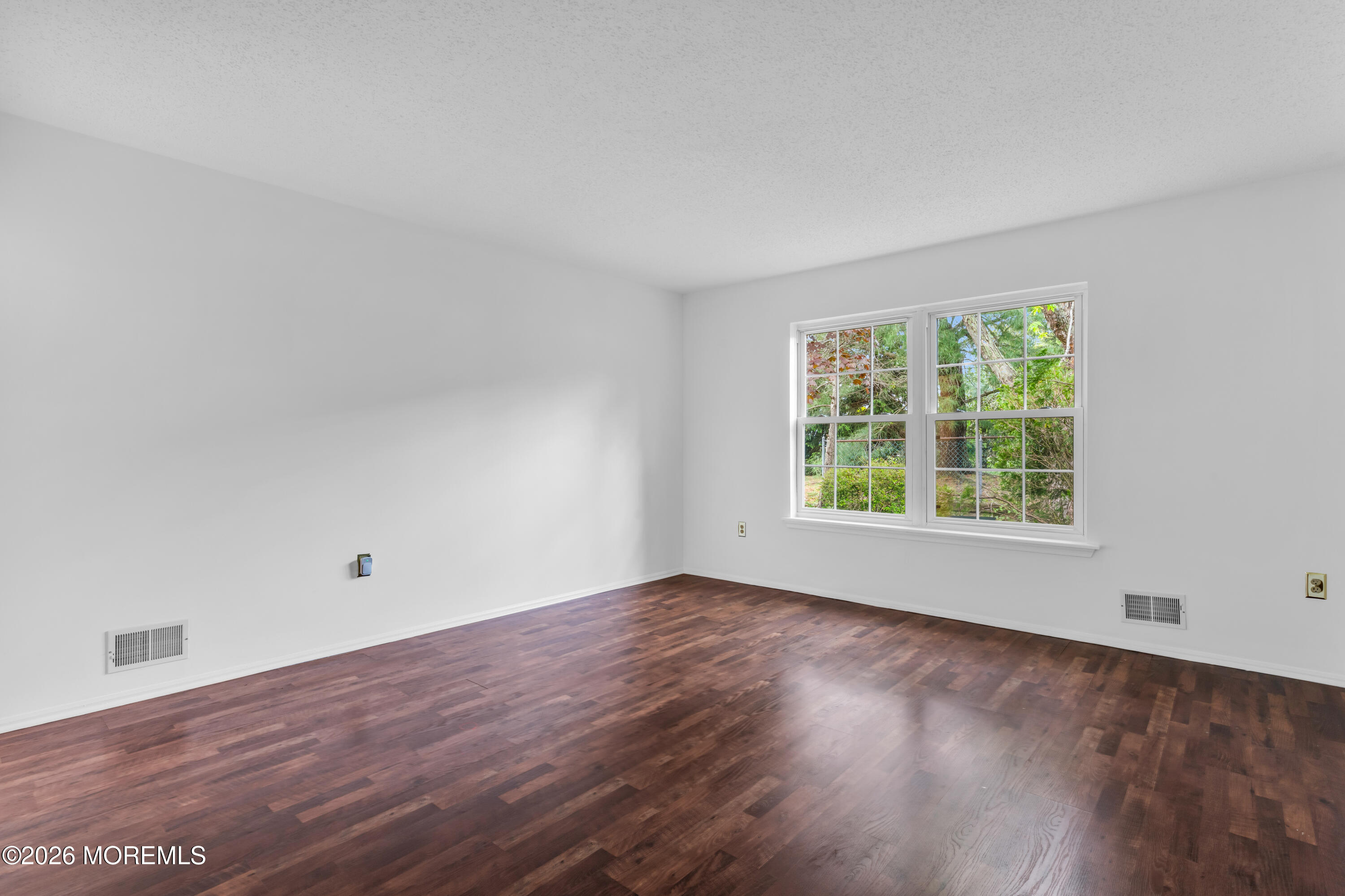 4 Brant Drive Brick, NJ 08724 - Photo 15 of 34 a view of an empty room with wooden floor and a window