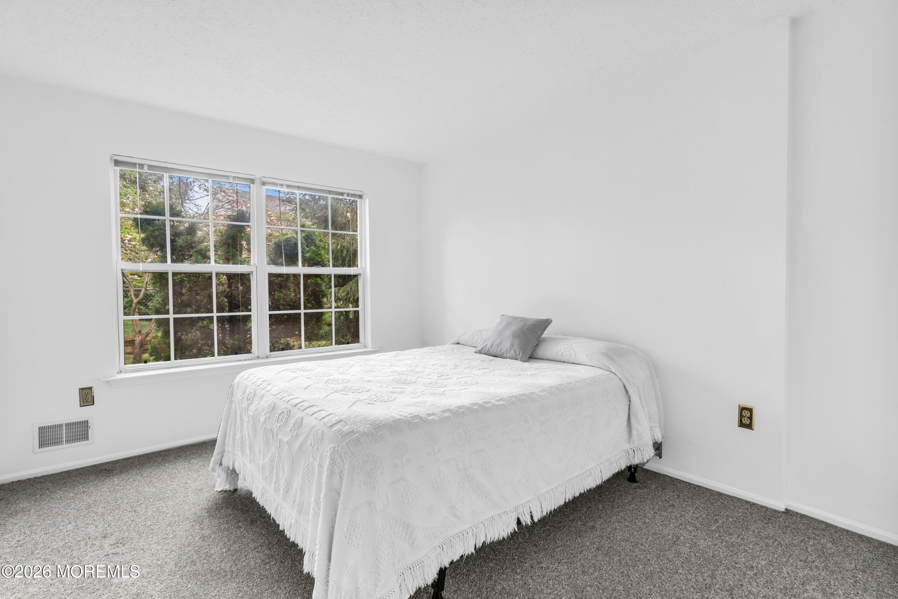 4 Brant Drive Brick, NJ 08724 - Photo 22 of 34 a large bed sitting in a bedroom next to a window
