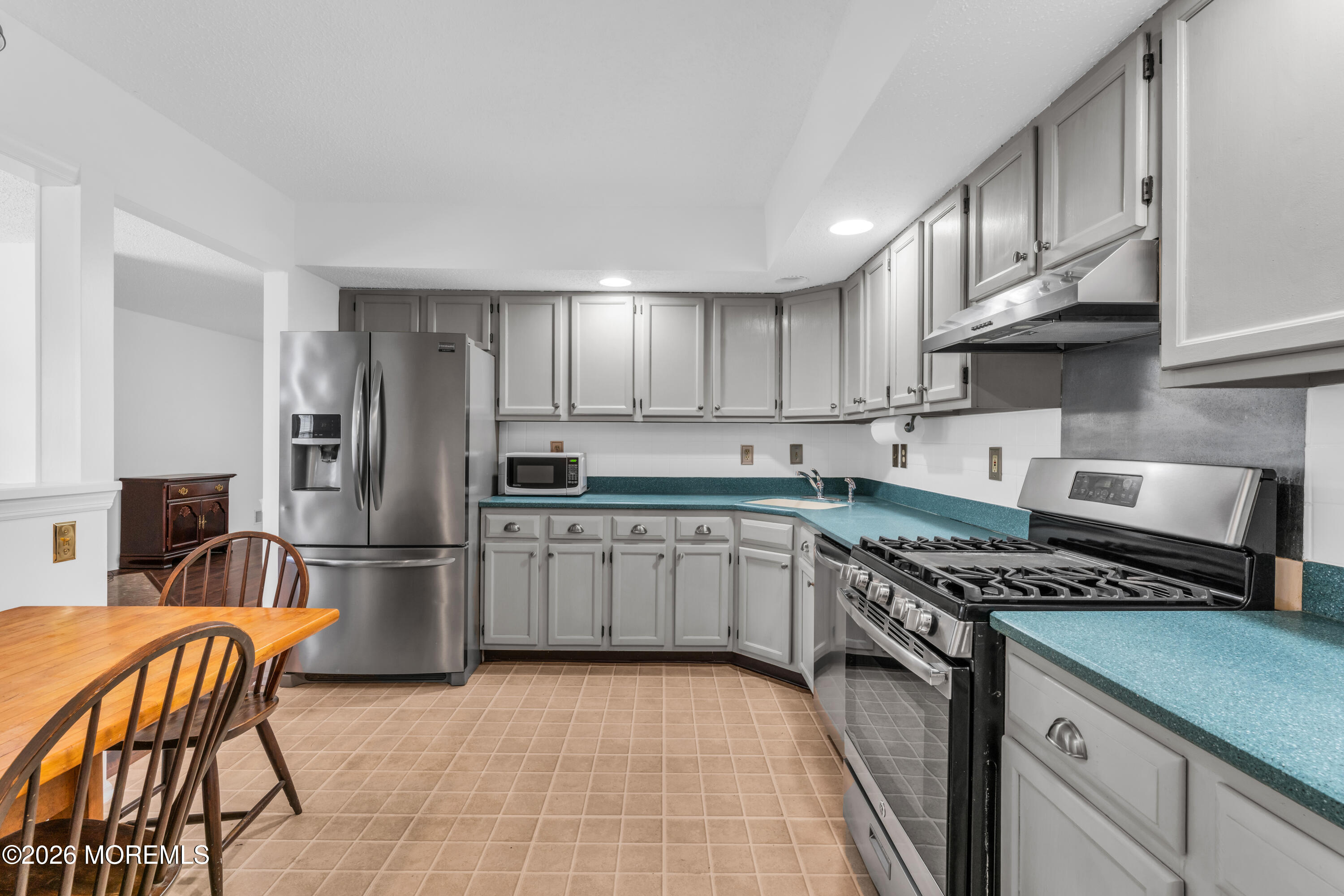 4 Brant Drive Brick, NJ 08724 - Photo 7 of 34 a kitchen with stainless steel appliances granite countertop a stove top oven a sink dishwasher a refrigerator and cabinets