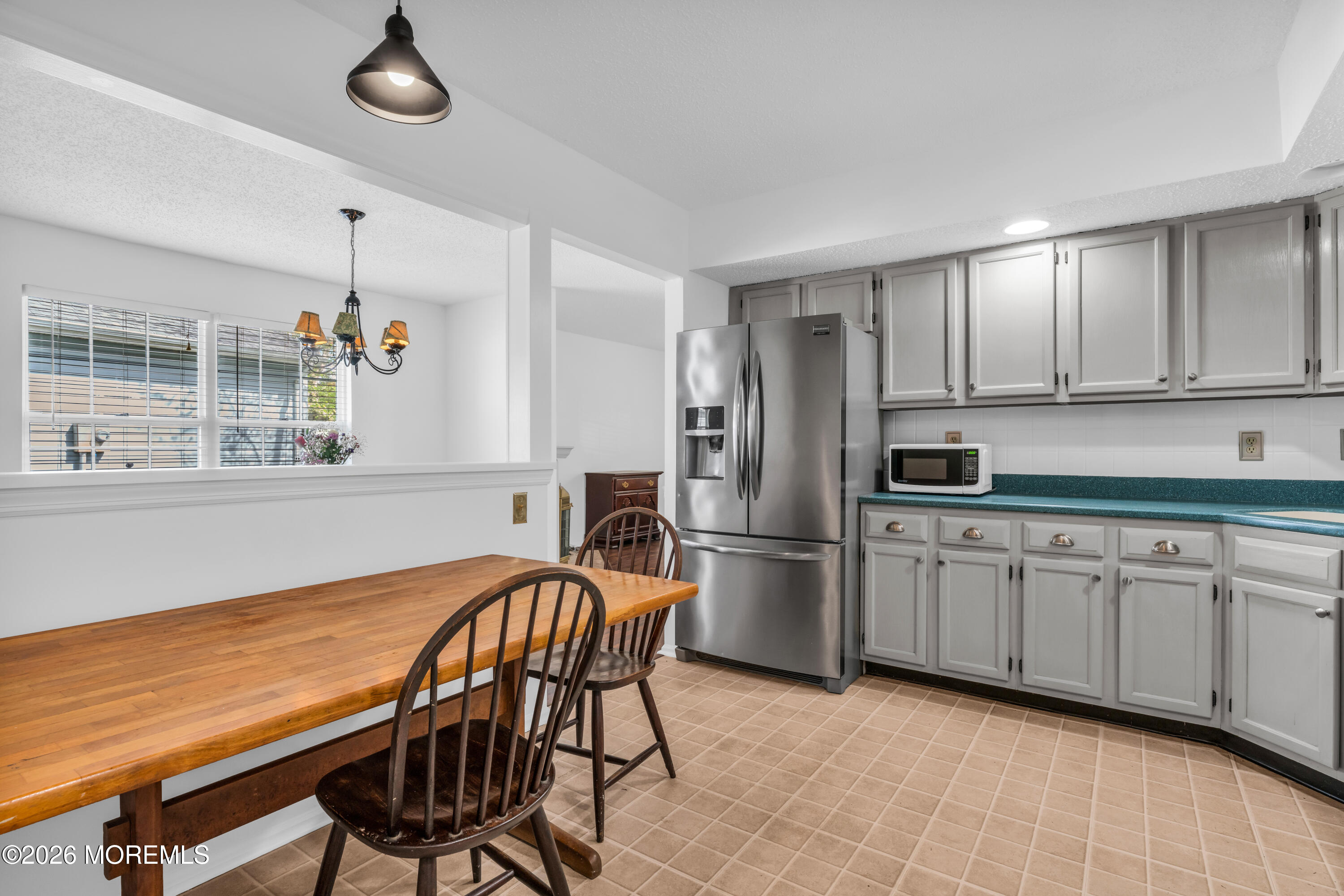 4 Brant Drive Brick, NJ 08724 - Photo 8 of 34 a kitchen with stainless steel appliances granite countertop a stove a refrigerator a sink dishwasher with a dining table and chairs