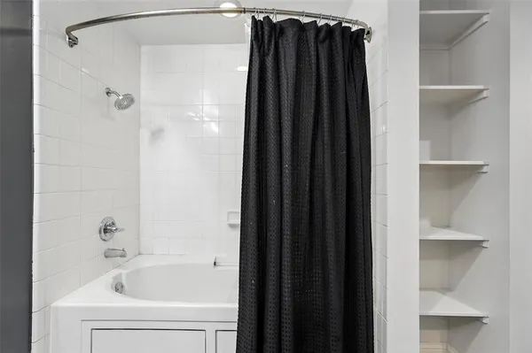a bathroom with a shower and a bathtub