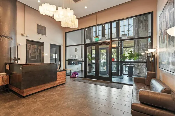 a living room with furniture and a chandelier
