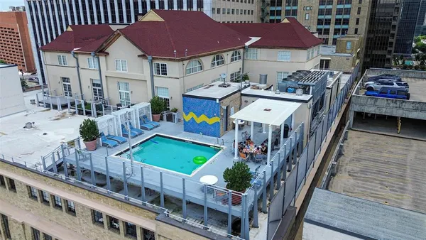 a view of multiple houses with deck and patio