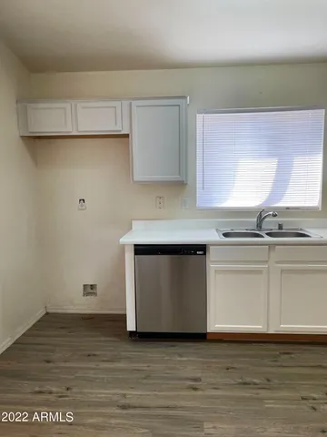 a kitchen with white cabinets and a sink