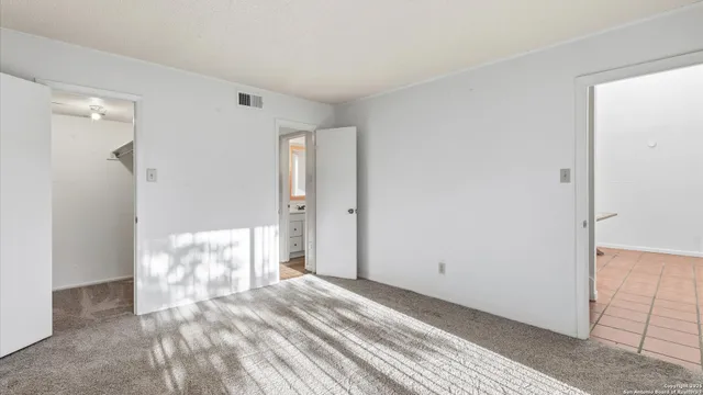 a view of a bedroom with wooden floor