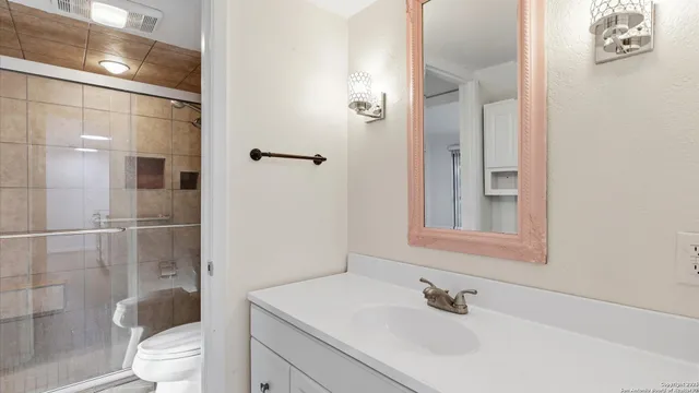 a bathroom with a sink toilet and shower