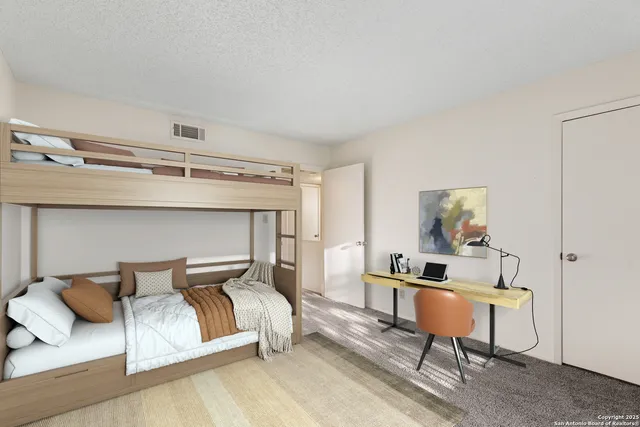 a bedroom with a bed and a lamp on table