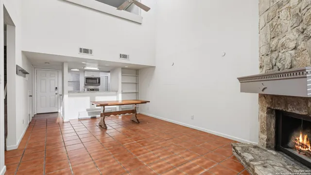 a view of a livingroom with wooden floor and a fireplace