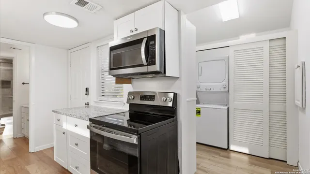a kitchen with a stove microwave and sink