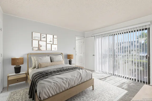 a bedroom with a bed and a window